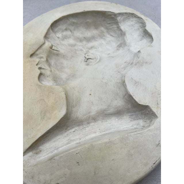 A single antique oval shape intaglio or plaster relief carving featuring a silhouette of a female.
