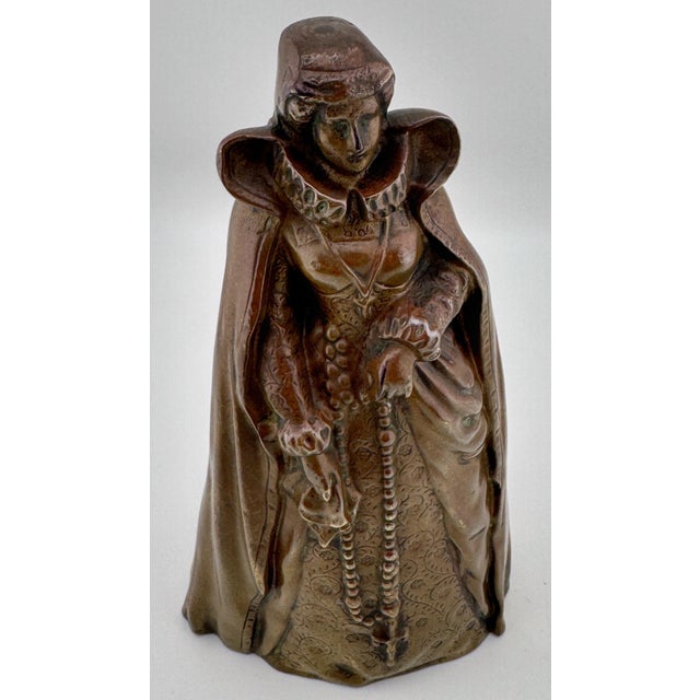 Virtue Above, Mischief Below: Gothic Revival Bronze Figural Bell with Leg Clappers, circa 1900 This finely cast Gothic...