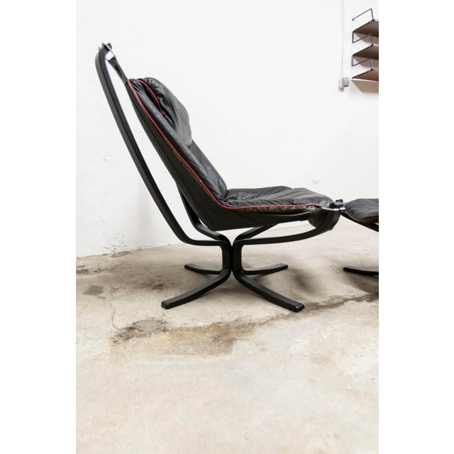 Viking armchair P97 by Sigurd Ressel for Poltrona Frau, circa 1980, with matching ottoman. Both pieces are signed. The...