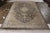 A 7x11 vintage Qum rug in a regal medallion style, enjoying hues of beige-brown atop black with comfortable blue accents....