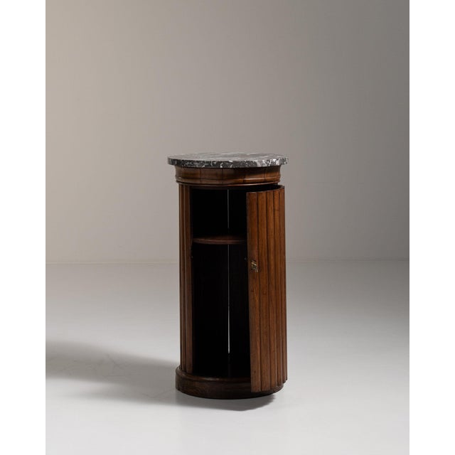 Fluted walnut pedestal cabinet in Rich Walnut Brown. Its rich walnut brown finish sets off marble top, fluted cylindrical...