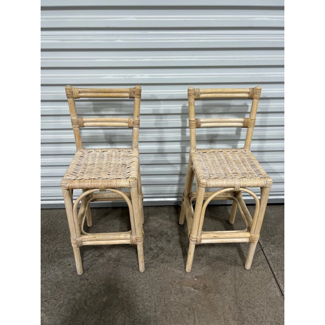 Exceptional set of vintage bohemian bamboo rattan stools. Each feature a woven seat. Sold as a set of 2.