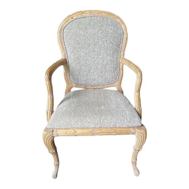 Offered is a vintage armchair with white washed faux bois design and original neutral upholstery.