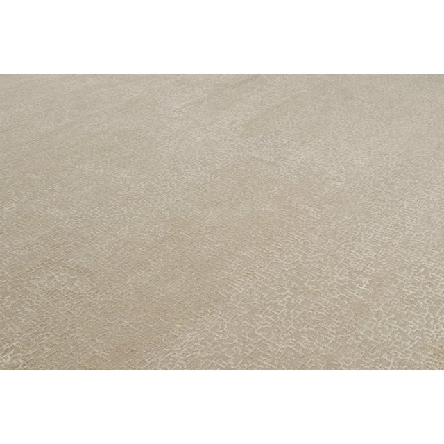 Hand-knotted in wool and silk, this 13x21 smart work both contemporary and textural from Nepal, features variations in...