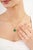 This minimalist solitaire pendant features a 6.06-carat emerald-cut green emerald, set in 14k yellow gold. The center...
