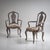 Elegant pair of 19th-century armchairs featuring gracefully curved armrests and baroque-style cabriole legs. The sculpted...