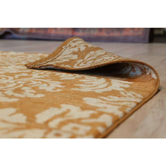 A 3' x 14' hand-knotted wool runner with a gold and brown damask pattern, in a low, dense Afghan wool pile. Newly made in...