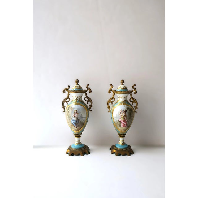 A beautiful and rare pair of French Sèvres porcelain bronze-mounted urns, Neoclassical/Rococo design period, circa 19th...