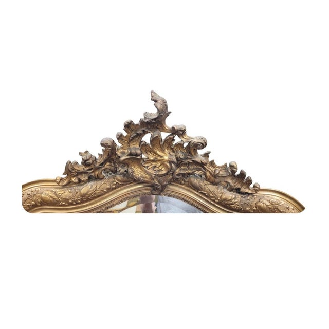 Fabulous antique Louis XV French guilt mantel mirror. Features leaf and berry border design French scroll leaf top and...