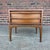 This is a Lane Rhythm walnut nightstand. It features clean simple lines and one large drawer for storage.