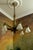 French Art Deco six-light chandelier, circa 1920s. Elegant chandelier crafted in bronze with six frosted white molded...