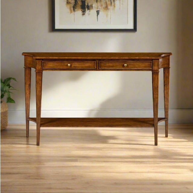 A Classic Rustic warm stained console table with a shaped top with incurved ends, on square tapered legs with a long...
