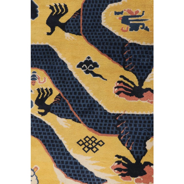 Hand-knotted in wool, this antique 4x15 Chinese Ningxia pillar runner from circa 1920–1940 features a dramatic dragon...