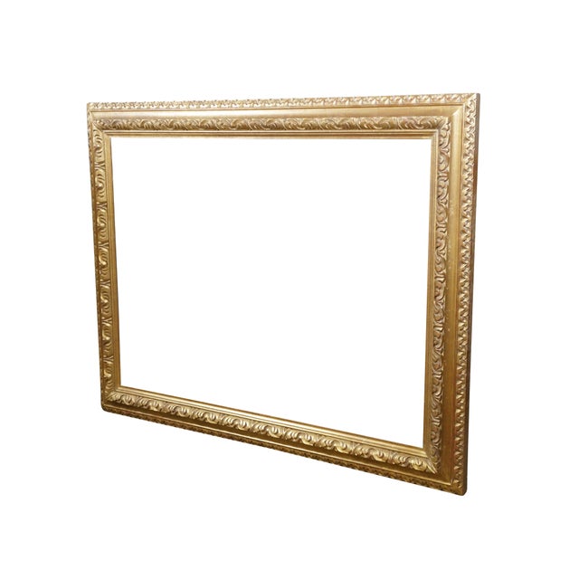 Late 20th century gilt wood picture / art / mirror frame. Beveled edge trimmed with a carved foliate pattern. Circa 2000....