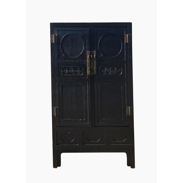 This lovely antique Chinese cabinet features a tall, narrow silhouette and a beautifully aged black finish. The two...