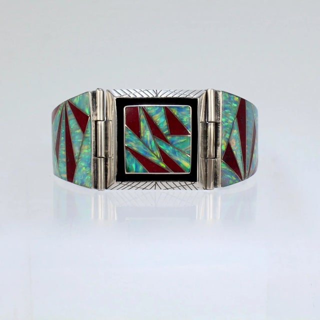 A vintage, artist signed old pawn bracelet. In sterling silver and set sharp-angled, geometrically cut cultured opal and...
