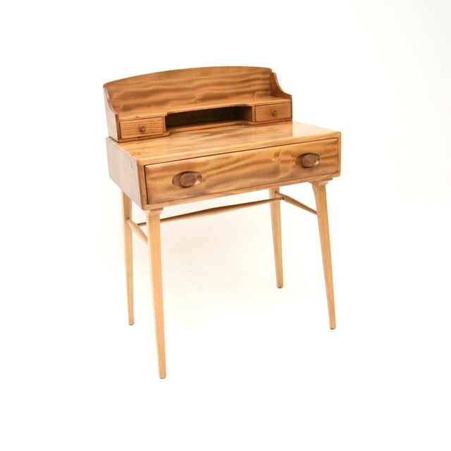 A beautiful and extremely well made vintage Ercol writing desk in solid elm. This was made in England, it dates from the...