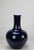 This vase with glossy dark blue finish has long straight neck and smooth rounded base. Each one is hand made by an artisan...