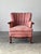 This vintage armchair carries all the romance of Louis XV design — cabriole legs, scrolled carved arms, and a curved...