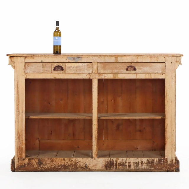 A handsome painted French pine bar counter, circa 1880, featuring columned details along the front and sides. The open...