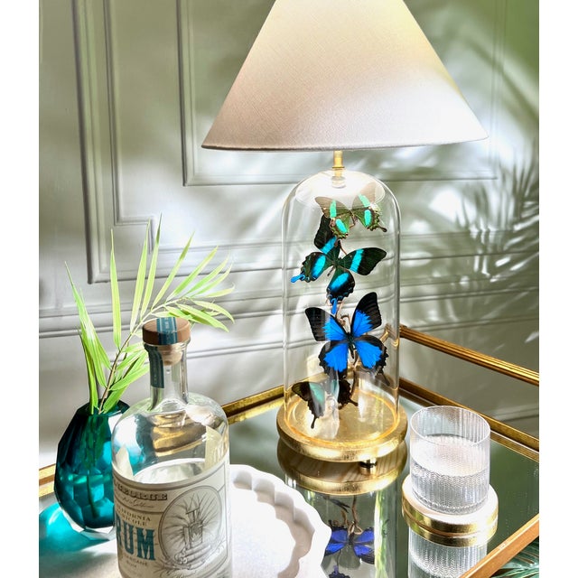 This is a hand made cloche lamp with real butterflies inside. The base is made of wood, gold leafed with brass feet and a...