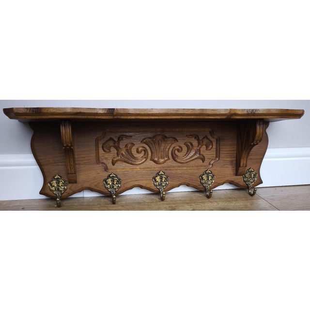 A beautifully styled Vintage French coat hanger, showcasing classic craftsmanship with a rich oak finish, elegant carved...