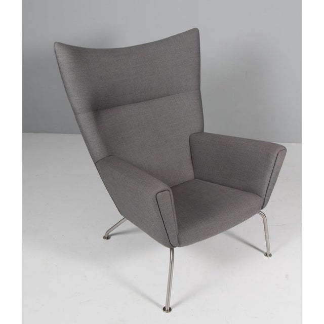 Hans J. Wegner lounge chair / wing chair original upholsterd with aniline leather. Frame of brushed steel. Model CH448,...