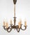 Antique chandelier made of patinated brass in the rococo style. Rarer model with cut-out bowls. The chandelier has...