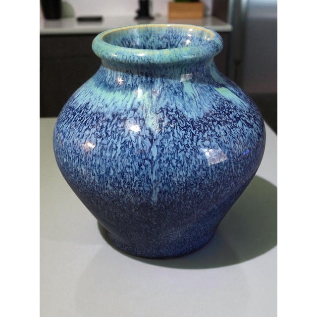 This vintage art pottery blue glazed vase features a mid-century modern style, with a glossy finish and a beautiful blue...