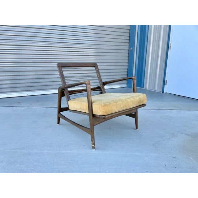 Mid-century teak lounge chair styled after Ib Kofod Larsen in Denmark circa 1960s. This beautiful lounge chair features a...