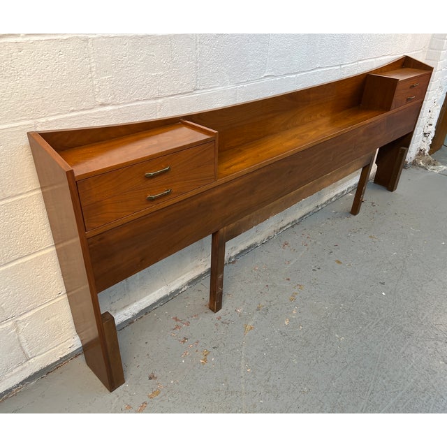 A rare and highly functional piece of mid-century modern bedroom furniture, this Young Manufacturing walnut king headboard...
