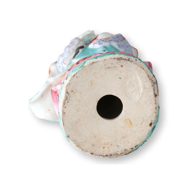 Hand-painted Chinese porcelain figurine of Guanyin, the Goddess of Mercy, rendered in a vibrant famille rose palette. She...