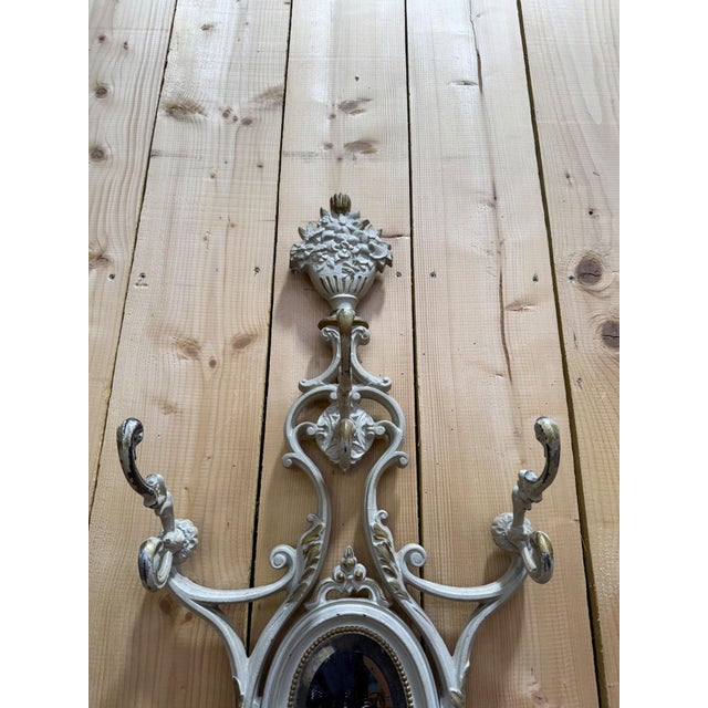 A freestanding coat rack in cast and painted cast iron, Art Nouveau period, circa 1900-1910. Its slender and symmetrical...