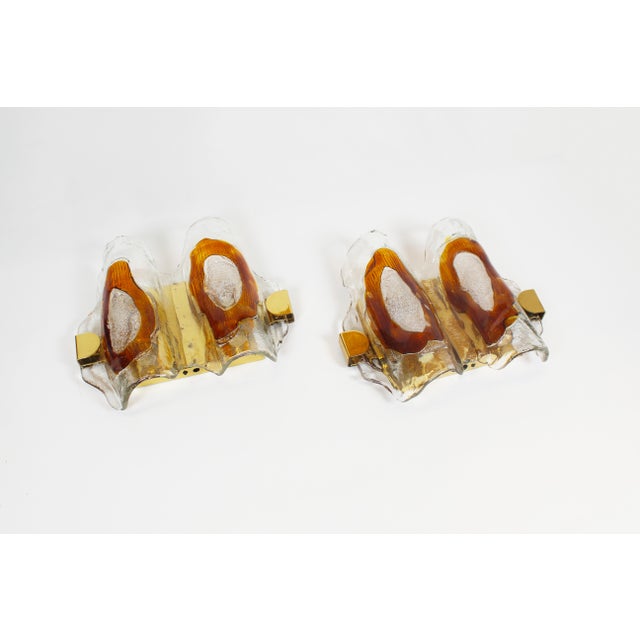 Beautiful and rare set of wall lamps by Hillebrand. Combination of hand-blown glass in brass holders. Both lamps are in...