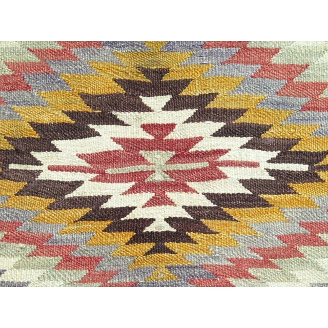 This beautiful, traditional vintage, flatweaved Turkish kilim rug is approximately 60 years old. It is handmade of very...