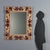 Baroque style mirror crafted from finely carved and gilded wood, dating back to mid-20th century Italy. The frame features...