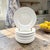 A matched set of nine Apilco Sèvres white porcelain appetizer plates, produced in France and dating to the late twentieth...