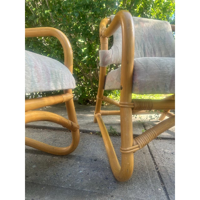 A charming pair of Danish bamboo lounge chairs, circa 1970s, with beautifully curved bamboo frames and soft diamond-...