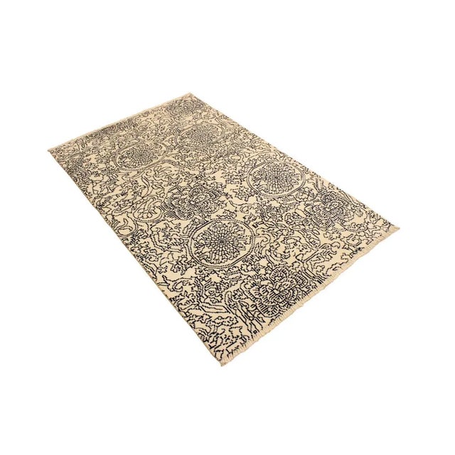 This elegant hand knotted rug features a modern fusion of beauty, with its interlocking geometric and minimalist pattern....