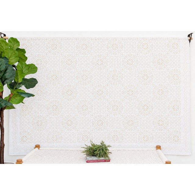 A lightweight cotton coverlet from Western India, beautifully adorned with intricate handcrafted appliqué cutwork. The...