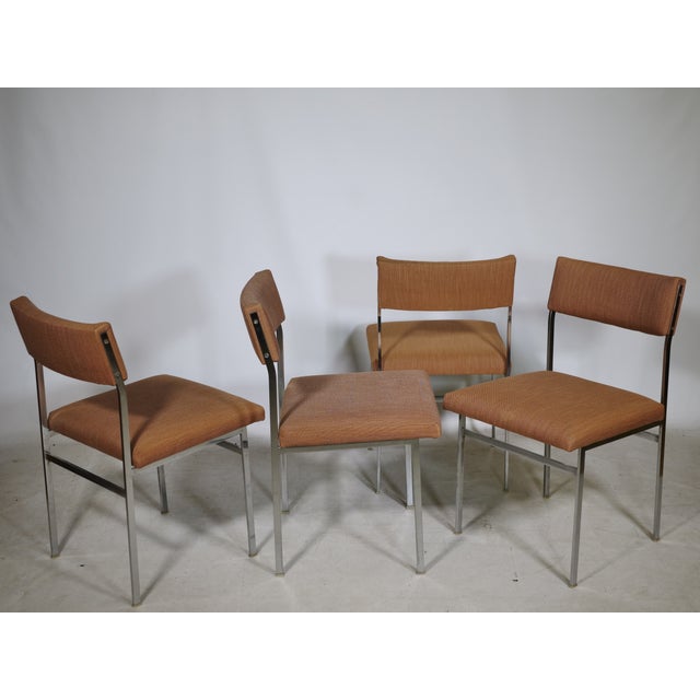 Set of four vintage chairs with chrome-plated metal frames and original fabric upholstery in a warm pastel pink. Padded...