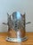 This elegant silver-plated wine holder is a refined example of classic English dining tradition, bringing a touch of high-...