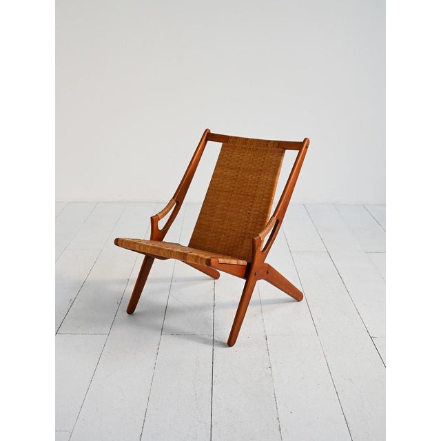 Teak armchair with woven rattan seat and back. Designed by Arne Hovmand-Olsen, 1950s. The "300" armchair, designed by Arne...