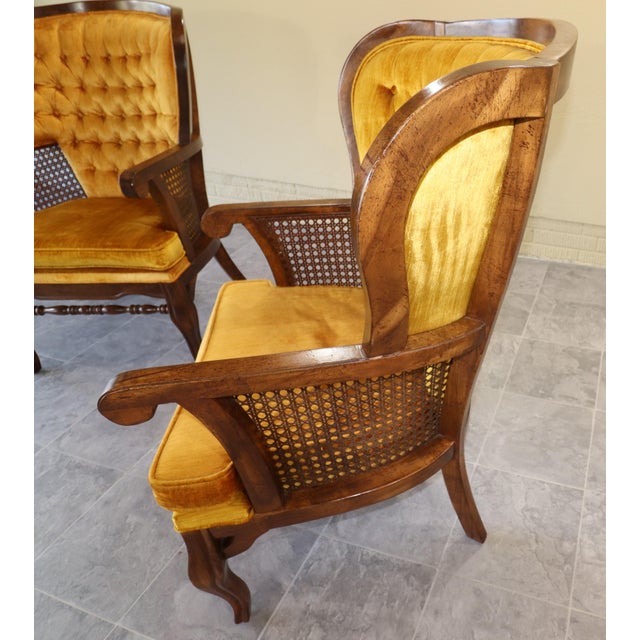 Exceptional pair of American Hollywood Regency cane and gold velvet lounge chairs, circa 1975–1980, distinguished by their...