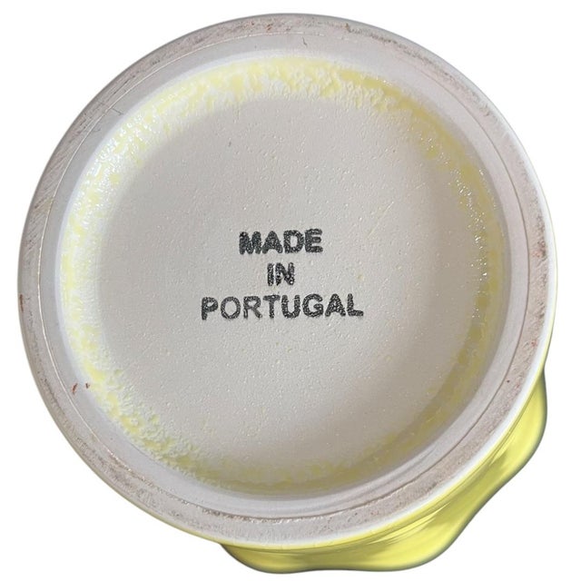 A vibrant Portuguese ceramic cachepot featuring a sunny yellow exterior and a fresh apple-green glazed interior. The piece...