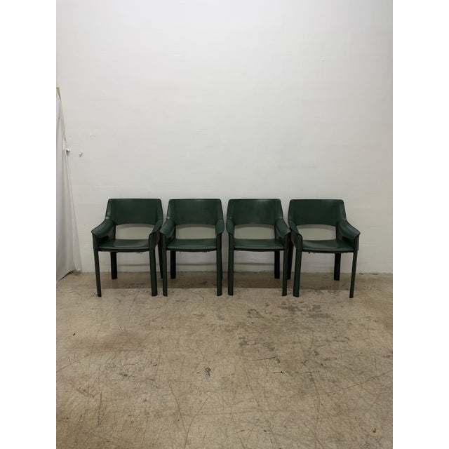 Set of four Mid-Century Brazilian modern dining armchairs manufactured by De Couro, 1980s. Each armchair features a...