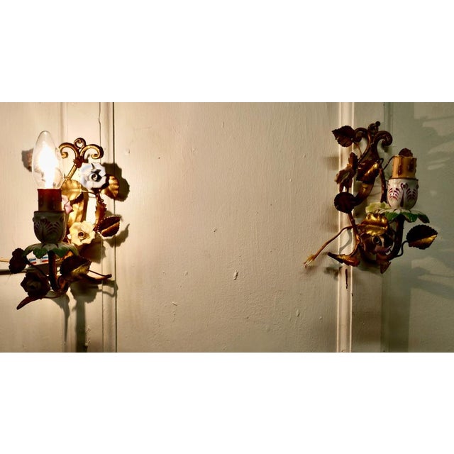 A pair of French ceramic and toleware gilded wall lights. These are very pretty pair of wall lights, the toleware sconces...