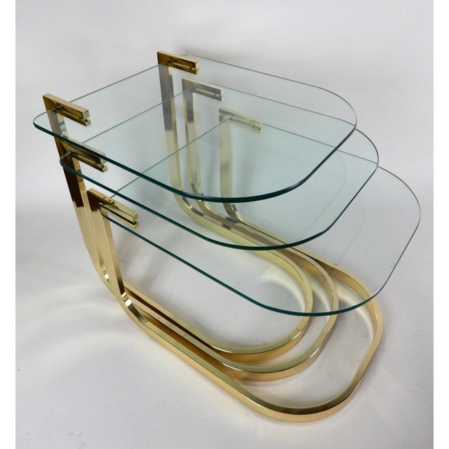 Nesting table set from the 1980's created by The Design Institute of America. Brass plated tubular steel frames with...