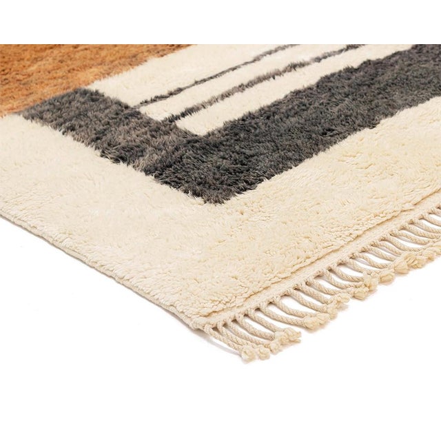 Bold blocks, arranged with architectural confidence. This hand-knotted Moroccan wool rug divides its surface into large,...