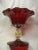 Fabulous Venetian hand blown ruby red, fluted edged bowl. Gold aventurine is encased in the clear glass pedestal. There...